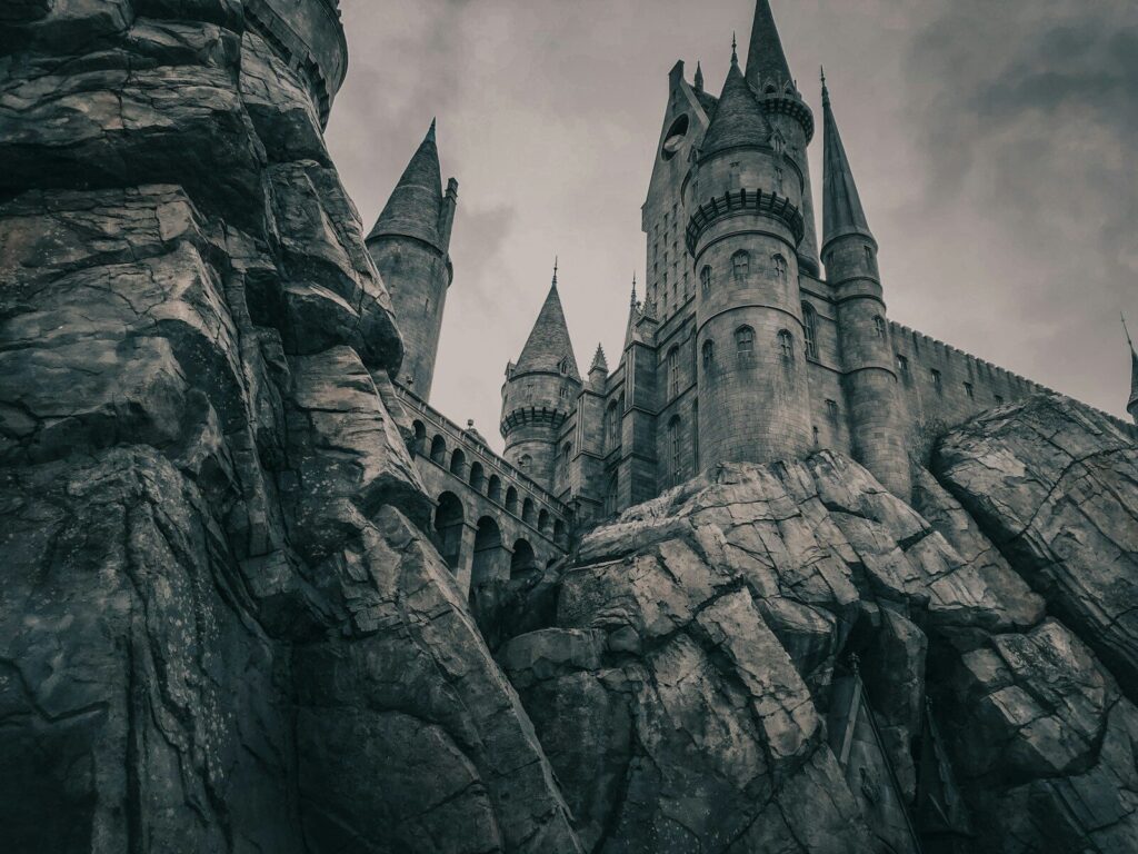 a large castle with towers on a cloudy day